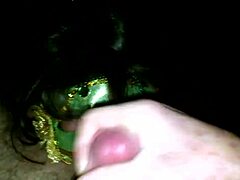 A mature woman in a green mask gives a blowjob and fucks a big cock