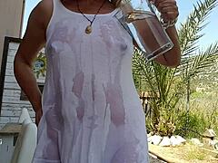 Extreme piercings and big nipples on busty mom in an outdoor setting