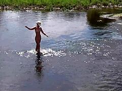 Une femme russe mûre prend un bain nu à l'air libre
